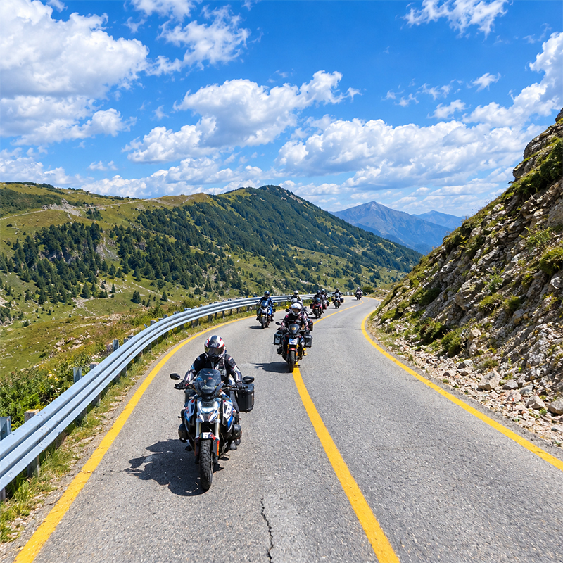 Motorcyclists along a panoramic road on the coast