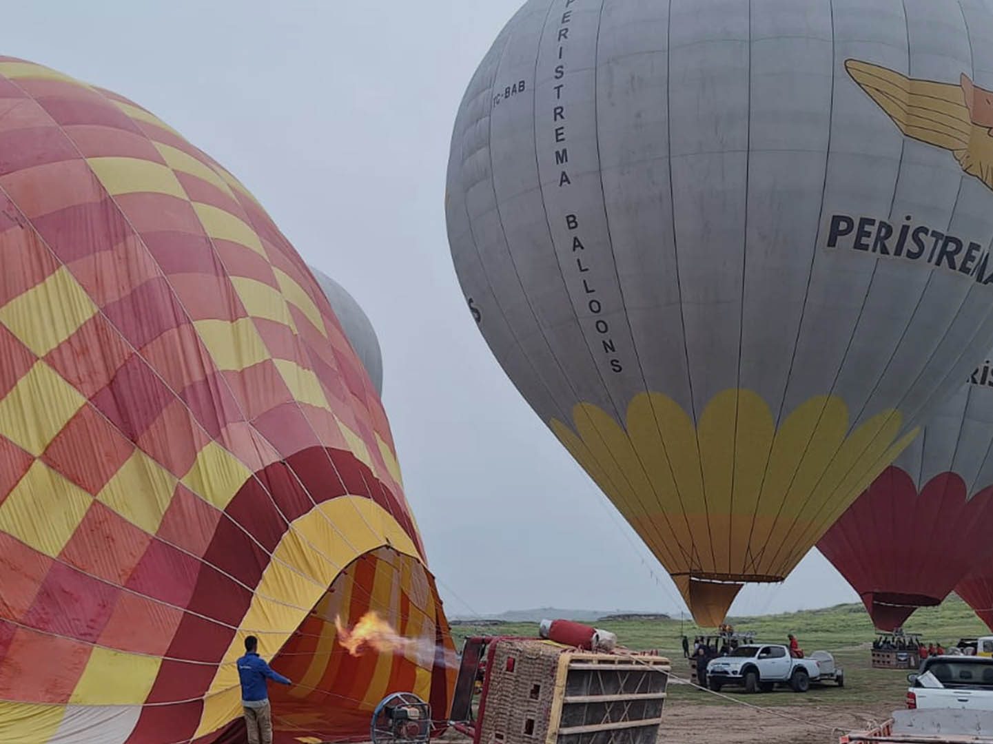 Hot air balloons prepare for flight at dawn